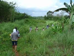 Mourners walking to Yusli's grave